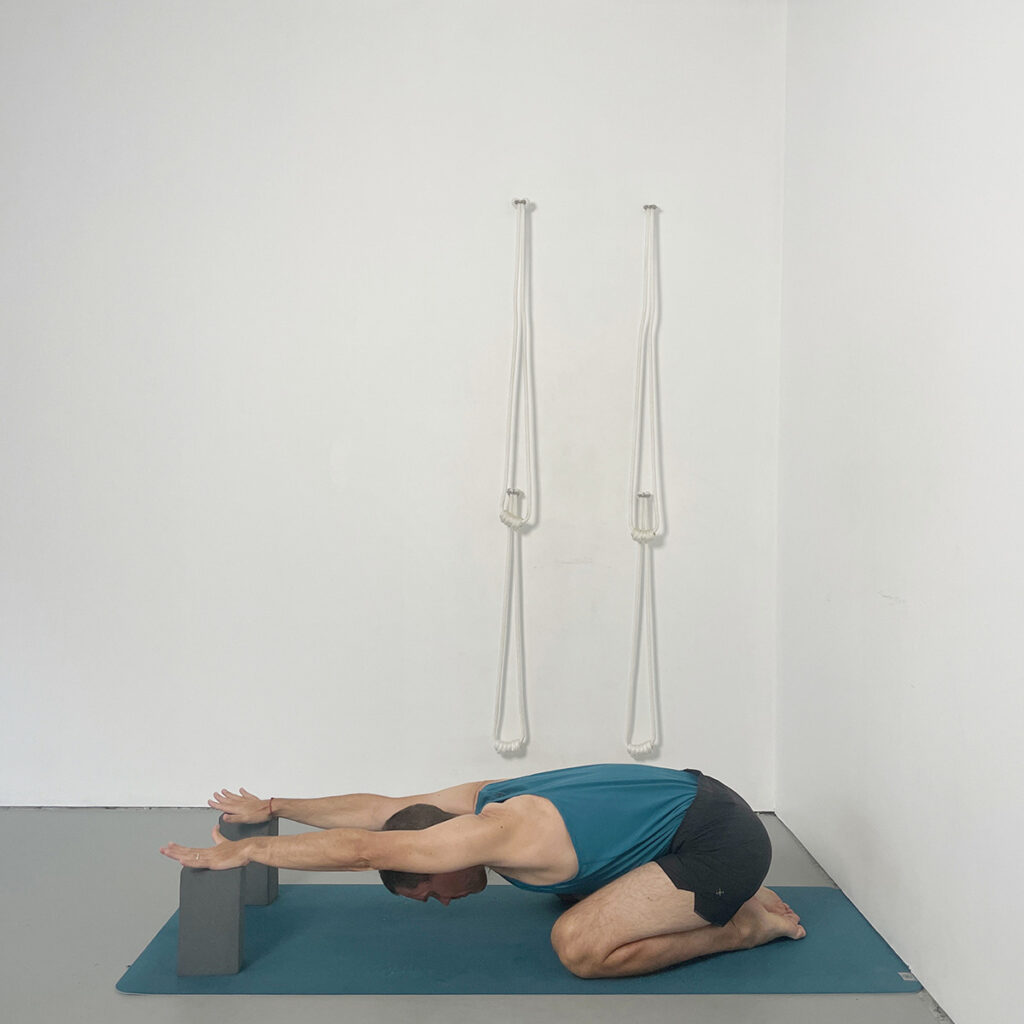 Adho Mukha Virasana (Virasana Forwards) with Hands on Blocks