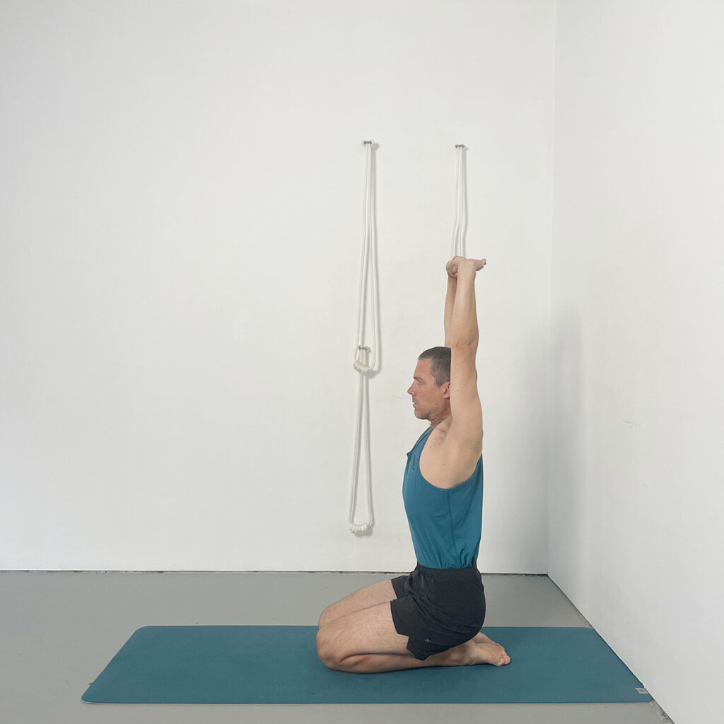 Parvatasana in Virasana (Arms Overhead in Kneeling)