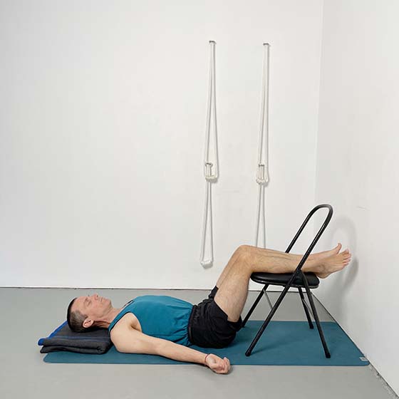 savasana with calves on a chair