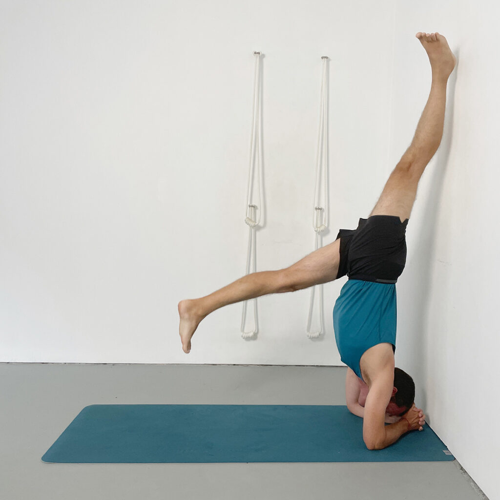 headstand prep kicking up with one heel