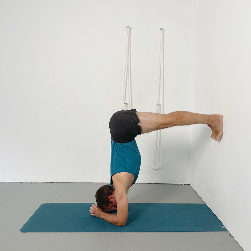 headstand preparation with feet to the wall